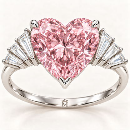 Close-up of the Pink Serenade pink heart, three-prong setting and eight baguette accents with official crown-M inner-band engraving