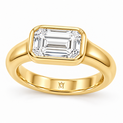 Serein east-west emerald-cut bezel engagement ring in 14K yellow gold, right three-quarter product view on white.