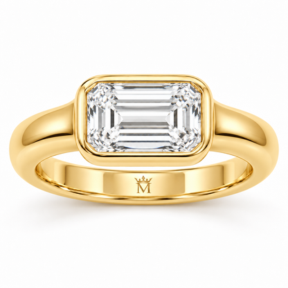 Serein east-west emerald-cut bezel engagement ring in 14K yellow gold, side profile on white.