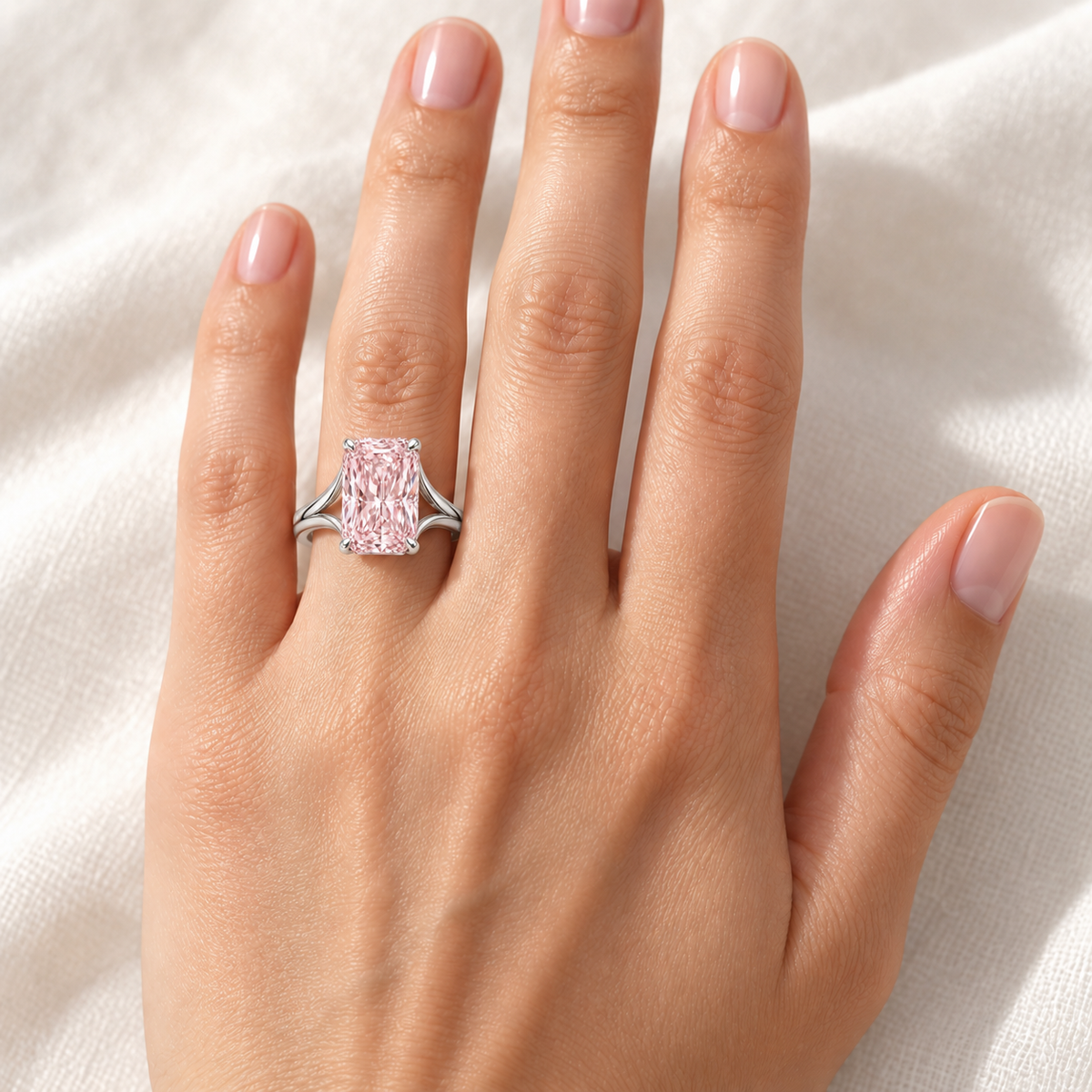AI design preview of Silk Frame pale pink radiant ring on adult left ring finger; scale illustrative
