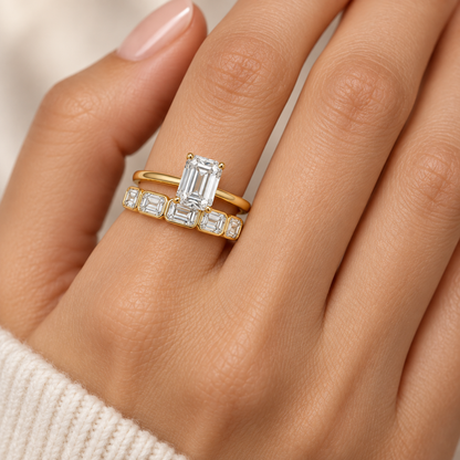 Solace east-west emerald-cut half-eternity wedding band in 14K yellow gold, worn by a model.
