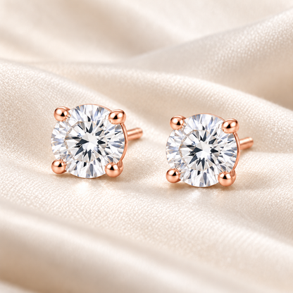 T13 round four-prong lab-grown diamond stud earrings in rose gold, matching pair on ivory fabric; design visualization