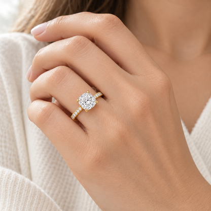 MISSISSI cushion-cut lab-grown diamond ring with pavé shoulders in yellow gold, shown worn on a hand