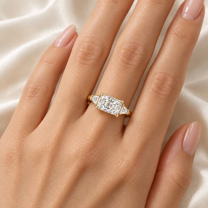 MISSISSI U03 east-west radiant lab-grown diamond three-stone ring in yellow gold, ring worn on an adult hand; design visualization