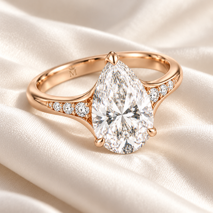 MISSISSI U04 pear lab-grown diamond contour ring in rose gold, ring resting on ivory fabric; design visualization