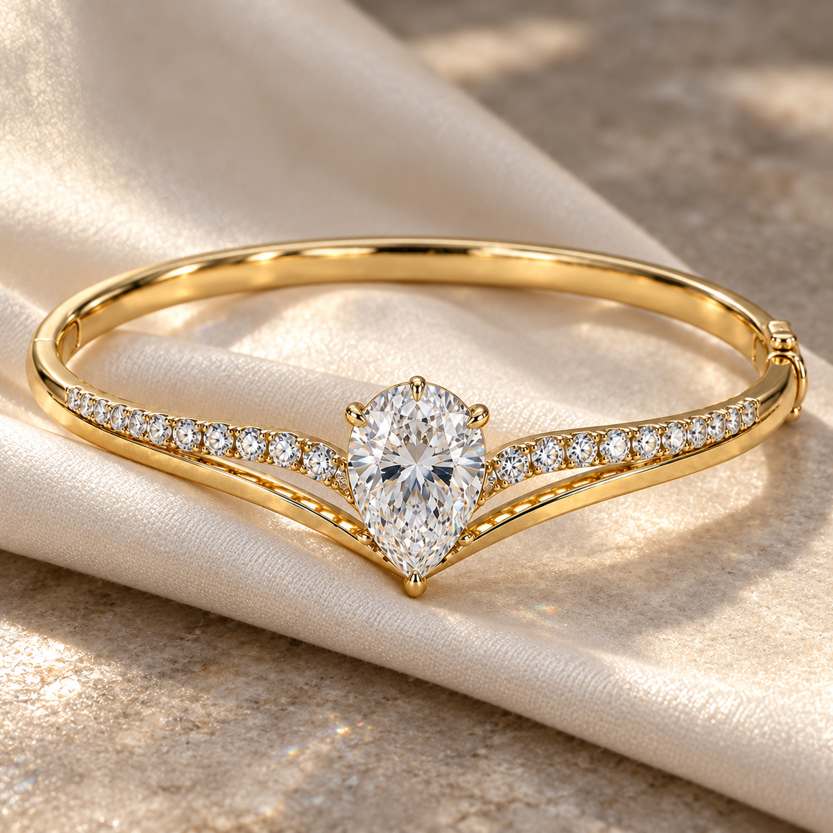 MISSISSI Pear V-Contour Lab-Grown Diamond Bangle in yellow gold, editorial silk and stone still life; design visualization