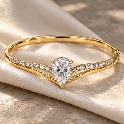 MISSISSI Pear V-Contour Lab-Grown Diamond Bangle in yellow gold, editorial silk and stone still life; design visualization