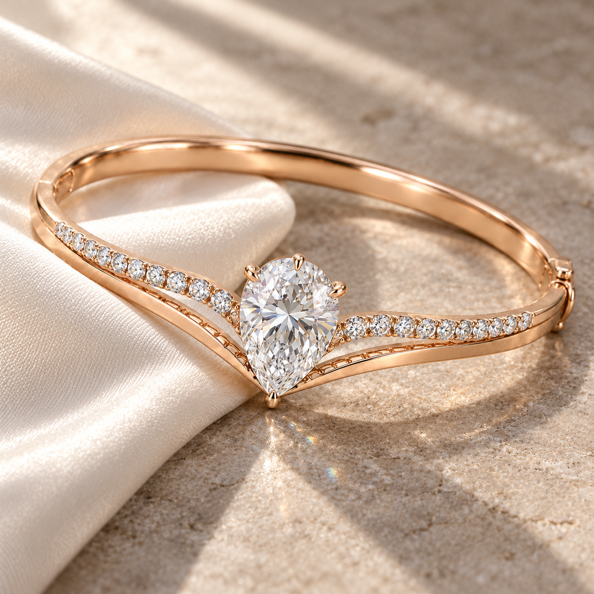 MISSISSI Pear V-Contour Lab-Grown Diamond Bangle in rose gold, editorial silk and stone still life; design visualization