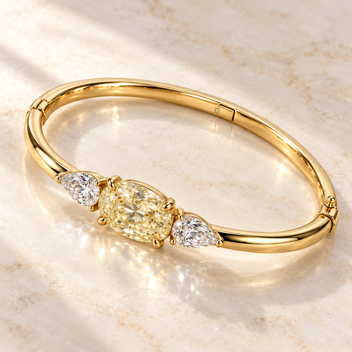 MISSISSI Yellow Oval Pear-Side Lab-Grown Diamond Bangle in yellow gold, angled product view on ivory stone; design visualization