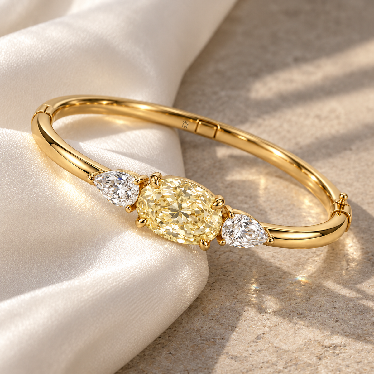 MISSISSI Yellow Oval Pear-Side Lab-Grown Diamond Bangle in yellow gold, editorial still life on ivory silk and pale stone; design visualization