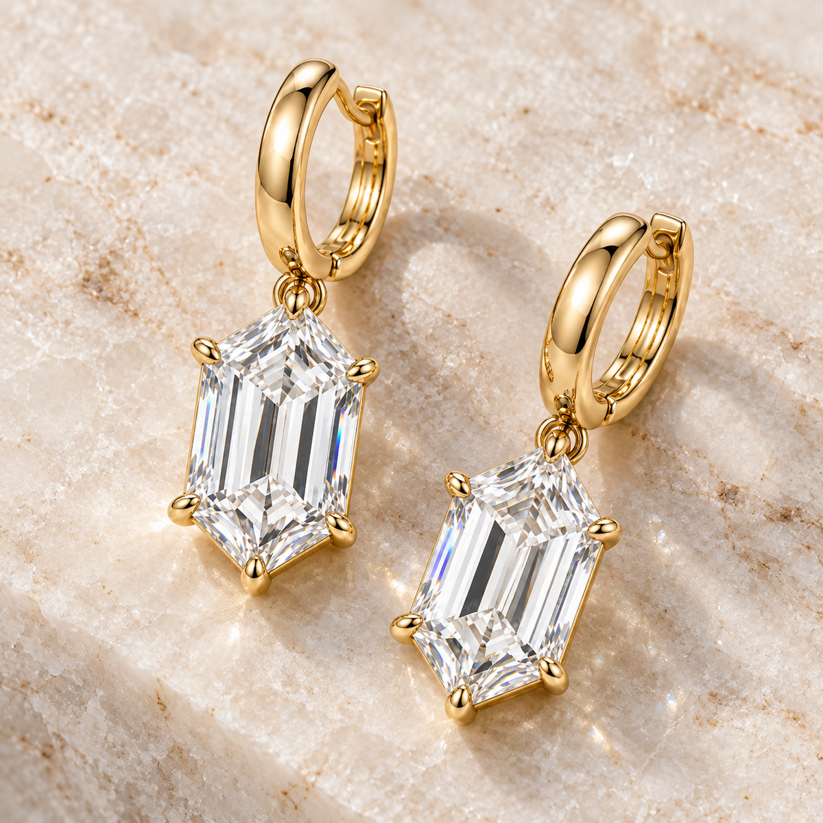 MISSISSI Hexagonal Huggie Drop Lab-Grown Diamond Earrings in yellow gold, angled product view on ivory stone; design visualization