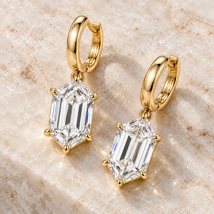 MISSISSI Hexagonal Huggie Drop Lab-Grown Diamond Earrings in yellow gold, angled product view on ivory stone; design visualization