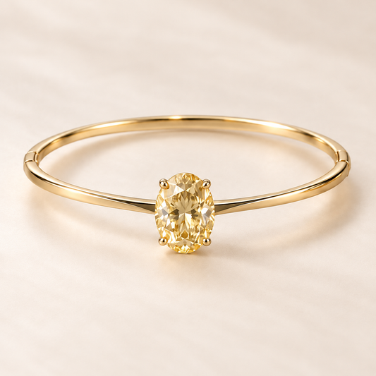 Design visualization of a slender closed bangle with a vertically set oval lab-grown yellow diamond in a four-prong setting