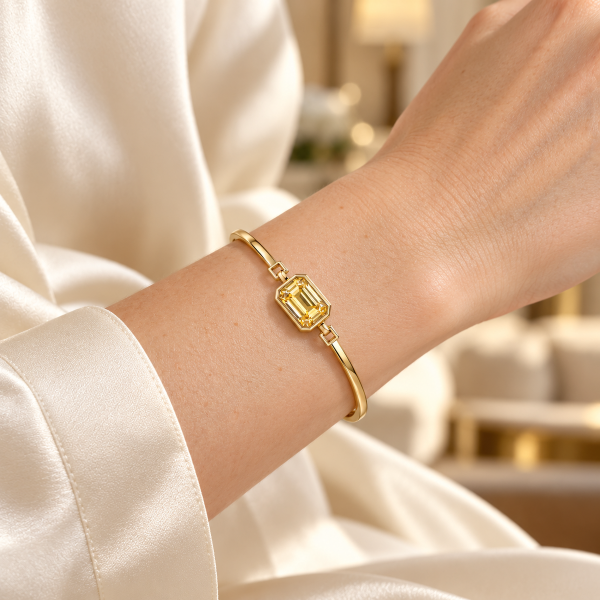 MISSISSI YB09 yellow diamond bezel bangle shown on a light skin wrist with an ivory silk cuff. Design visualization.