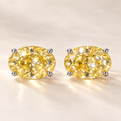 Design visualization of a pair of oval lab-grown yellow diamond stud earrings set horizontally in four-prong settings