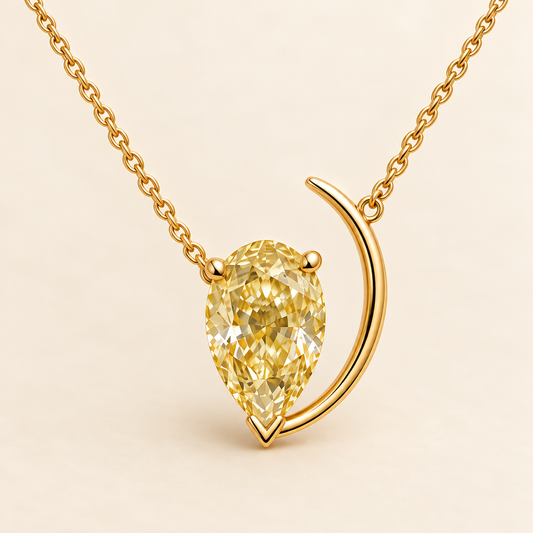 Design visualization of a downward-pointing pear-shaped lab-grown yellow diamond beside a slender crescent-shaped arc on a chain