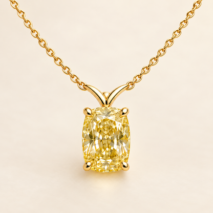 Design visualization of an elongated cushion-cut lab-grown yellow diamond pendant with a sculpted V-shaped connection to the chain