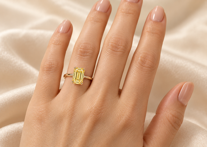MISSISSI YR02 vertical emerald-cut lab-grown yellow diamond solitaire ring worn on the ring finger of an adult left hand; design visualization