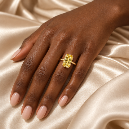 MISSISSI YR07 emerald-cut yellow diamond bezel ring, illustrative on-hand styling. Design visualization; not a scale guide.