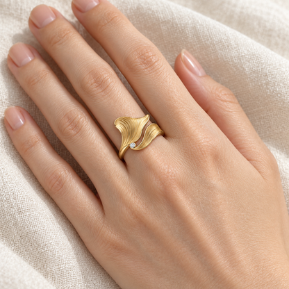 MISSISSI Petal Current sculptural two-petal ring concept, adult light-skin hand wearing view; design visualization