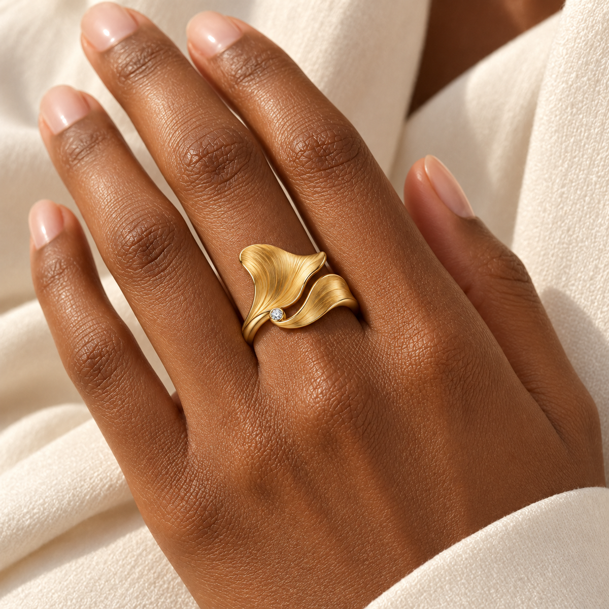 MISSISSI Petal Current sculptural two-petal ring concept, adult deep-skin hand wearing view; design visualization