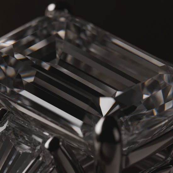 MISSISSI Emerald cut Prong-set center with two tapered baguette side stones ring advertisement. AI-generated design concept with champagne packaging.