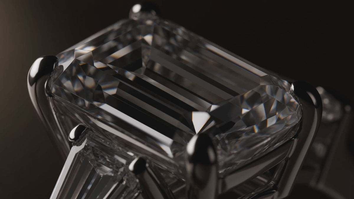 MISSISSI Emerald cut Prong-set center with two tapered baguette side stones ring advertisement. AI-generated design concept with champagne packaging.