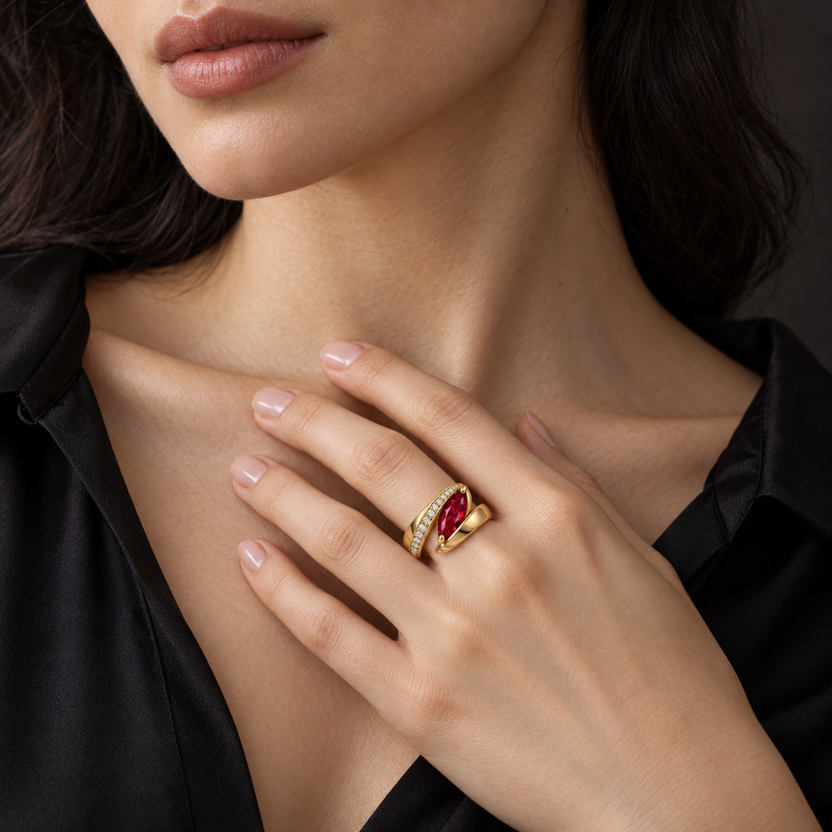 MISSISSI RB25 RIBBON FOLD yellow gold marquise lab-grown ruby ring worn by a fair-skin adult model with a black blouse; AI-generated design visualization.
