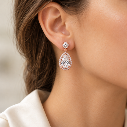 MISSISSI pear-halo lab-grown diamond drop earrings in rose gold, one earring shown worn on an ear