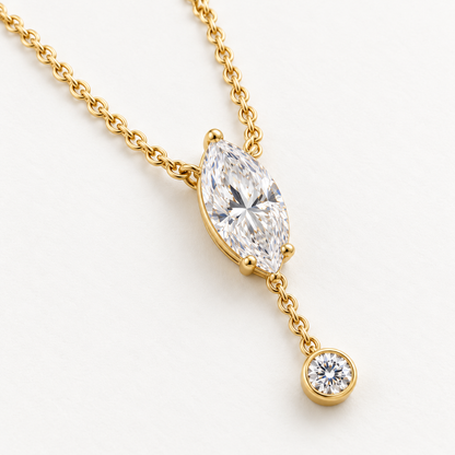 MISSISSI U08 Marquise Y Drop necklace in 14K yellow gold, three-quarter structure on ivory; design visualization with a vertical marquise diamond and a small round bezel-set diamond on a short chain drop.