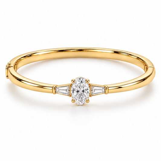MISSISSI U09 Oval and Baguette bangle in 14K yellow gold, front hero on white; design visualization of a closed oval bangle with a vertical oval diamond and two tapered baguette side diamonds.