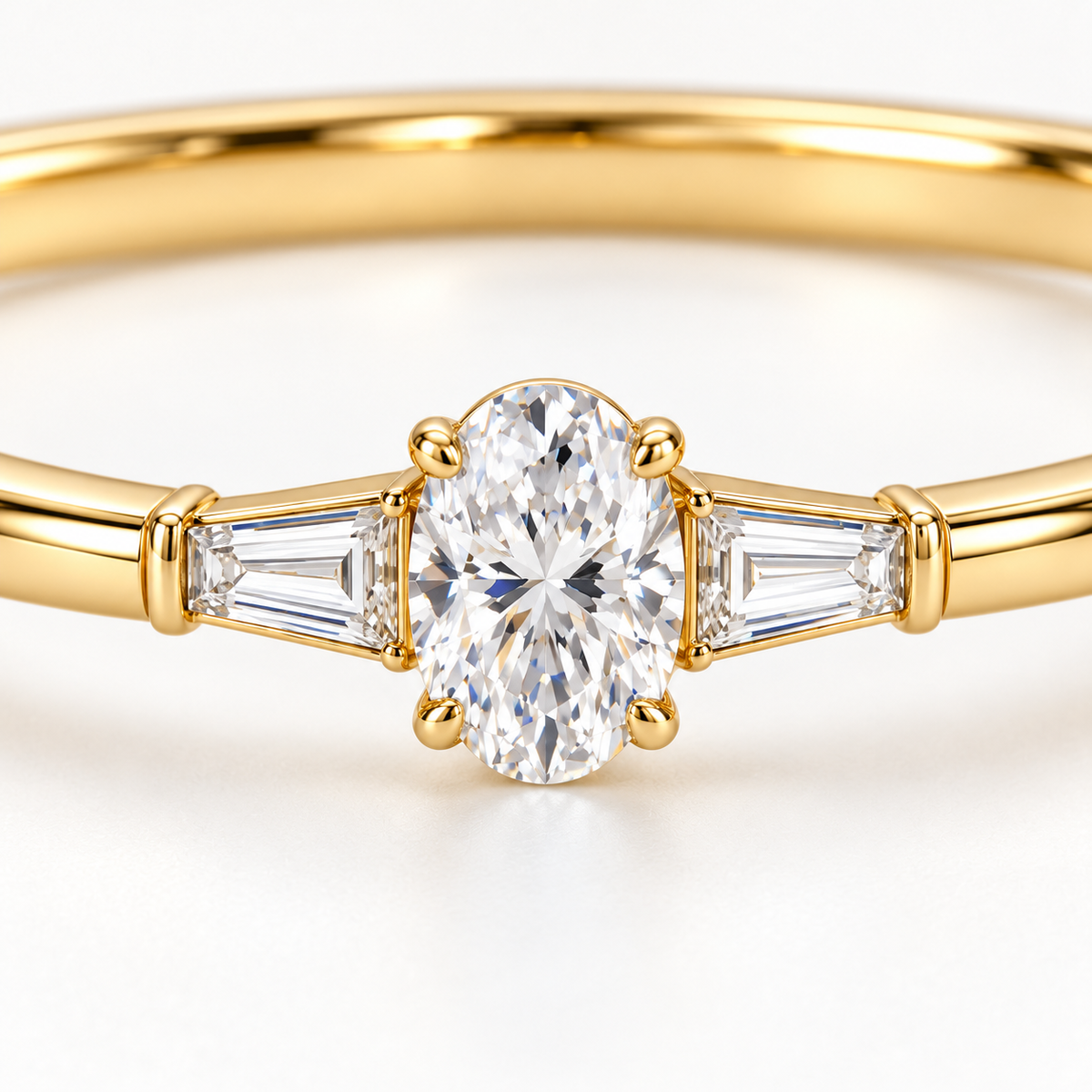 MISSISSI U09 Oval and Baguette bangle in 14K yellow gold, oval and tapered baguette diamond macro; design visualization of a closed oval bangle with a vertical oval diamond and two tapered baguette side diamonds.