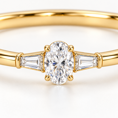 MISSISSI U09 Oval and Baguette bangle in 14K yellow gold, oval and tapered baguette diamond macro; design visualization of a closed oval bangle with a vertical oval diamond and two tapered baguette side diamonds.