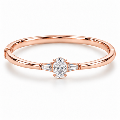 MISSISSI U09 Oval and Baguette bangle in 14K rose gold, front hero on white; design visualization of a closed oval bangle with a vertical oval diamond and two tapered baguette side diamonds.