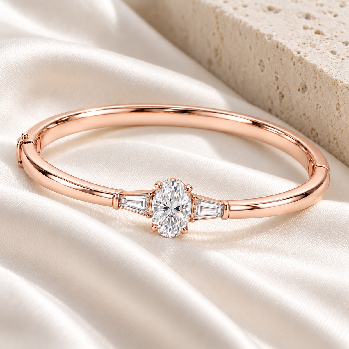 MISSISSI U09 Oval and Baguette bangle in 14K rose gold, ivory silk and pale stone styling; design visualization of a closed oval bangle with a vertical oval diamond and two tapered baguette side diamonds.