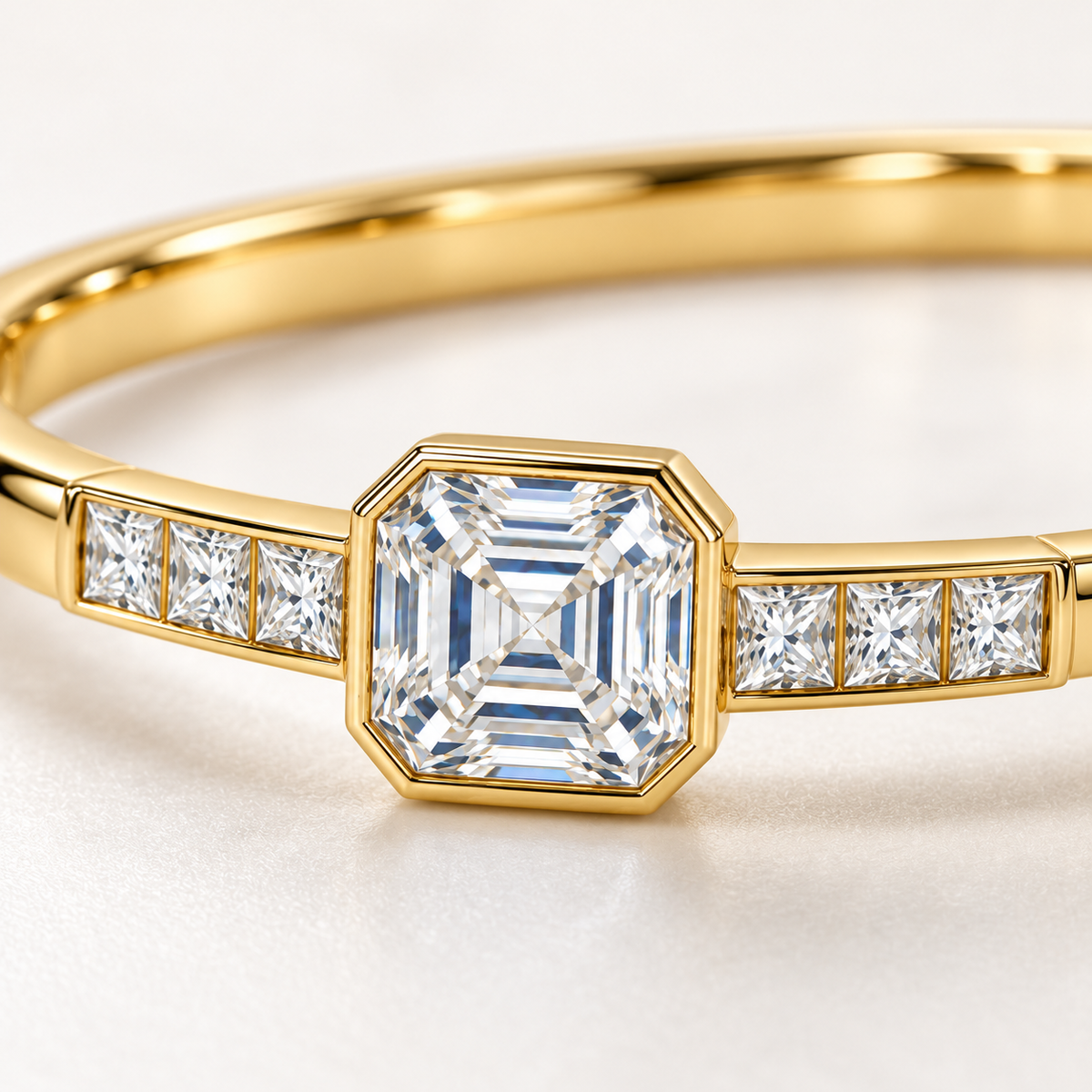 MISSISSI U10 Asscher-cut lab-grown diamond closed oval bangle in 14K yellow gold, setting macro, with three princess-cut diamonds on each shoulder.