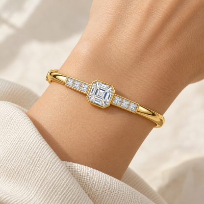 MISSISSI U10 Asscher-cut lab-grown diamond closed oval bangle in 14K yellow gold, adult wrist worn view, with three princess-cut diamonds on each shoulder.