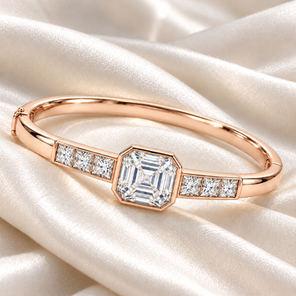 MISSISSI U10 Asscher-cut lab-grown diamond closed oval bangle in 14K soft rose gold, ivory silk still life, with three princess-cut diamonds on each shoulder.