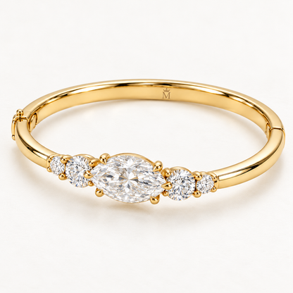 MISSISSI U12 east-west marquise-cut lab-grown diamond closed oval bangle in 14K yellow gold, three-quarter view, with two graduated round diamonds on each shoulder.