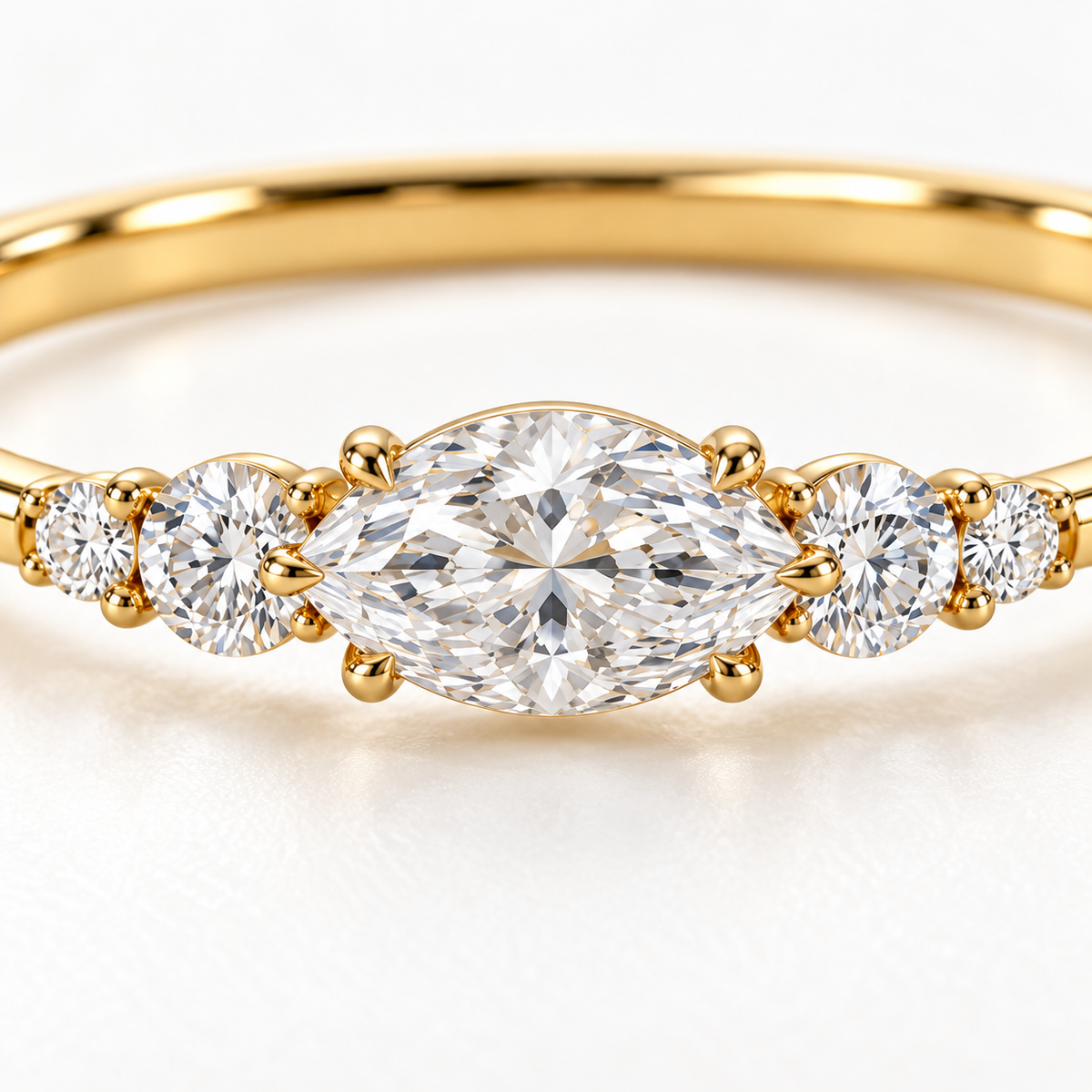 MISSISSI U12 east-west marquise-cut lab-grown diamond closed oval bangle in 14K yellow gold, setting macro, with two graduated round diamonds on each shoulder.