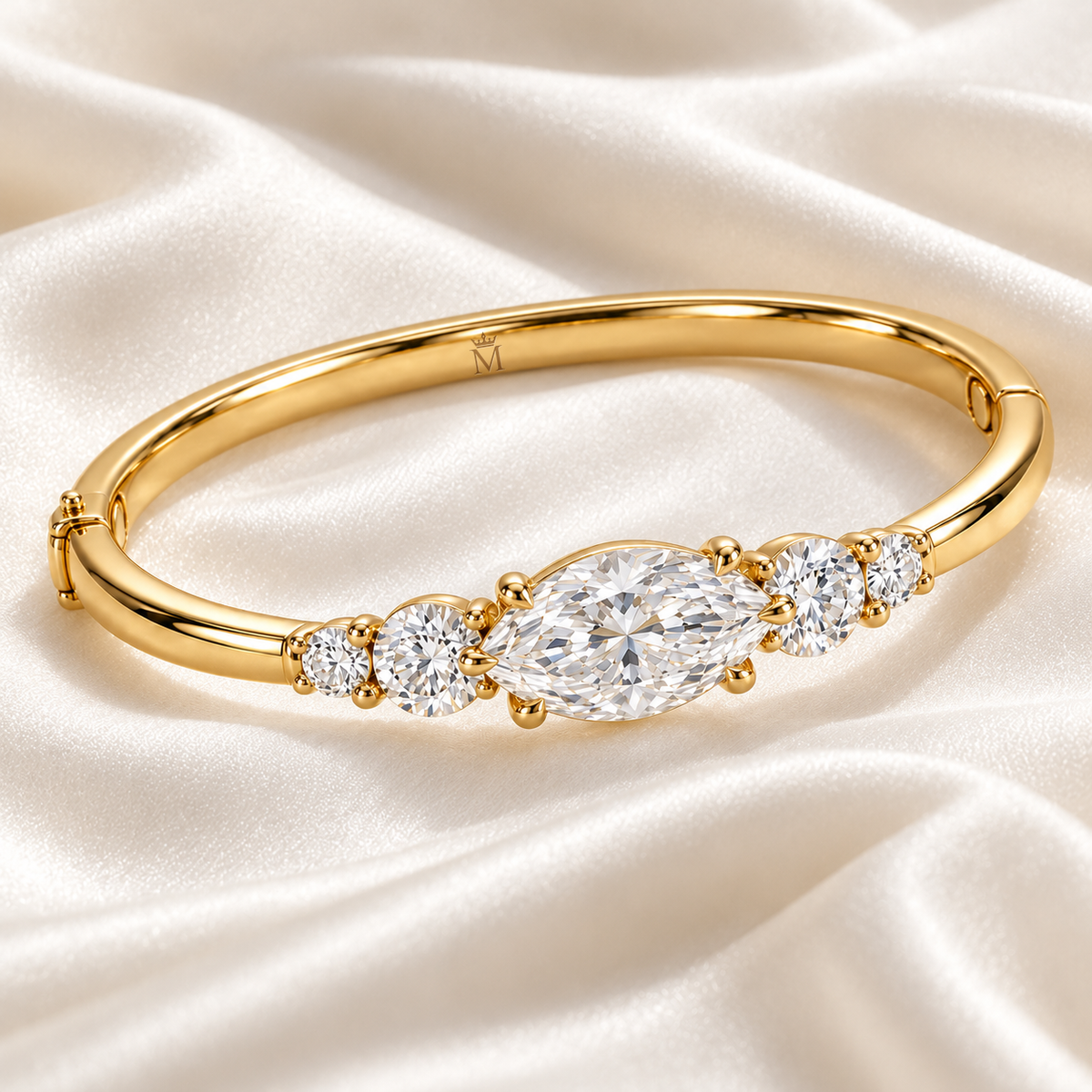 MISSISSI U12 east-west marquise-cut lab-grown diamond closed oval bangle in 14K yellow gold, ivory silk still life, with two graduated round diamonds on each shoulder.
