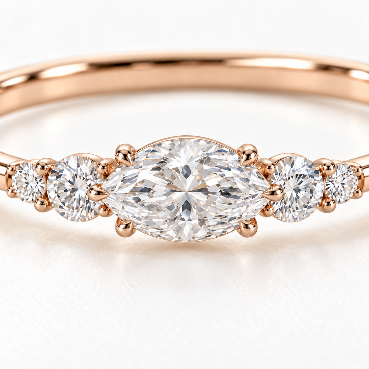 MISSISSI U12 east-west marquise-cut lab-grown diamond closed oval bangle in 14K soft rose gold, setting macro, with two graduated round diamonds on each shoulder.