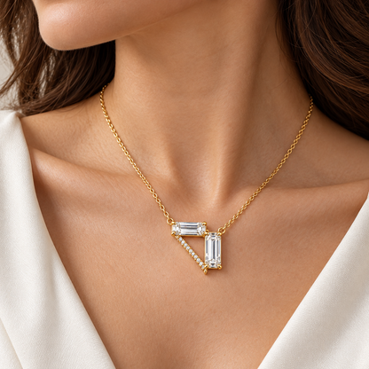 MISSISSI Z08 necklace in yellow gold tone on an adult wearer, showing a horizontal emerald-cut diamond, a vertical emerald-cut drop and a diagonal line of round diamonds forming an open triangle; design visualization