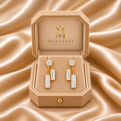 MISSISSI Diamond Parallel lab-grown diamond drop earrings in yellow gold, presented as a pair in champagne octagonal packaging with crown M branding; design visualization.